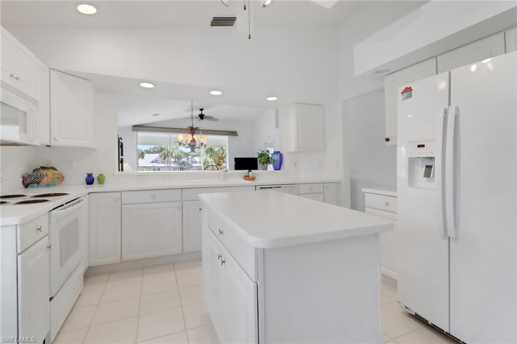 6180 Reserve Circle, Unit 203 Naples, FL 34119 - Photo 4 of 26 Very LIGHT and BRIGHT kitchen...looking towards living area and lake view
