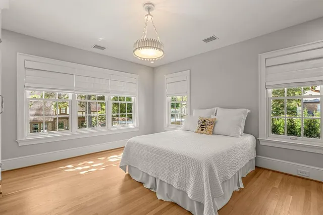 a bedroom with a large bed and a large window