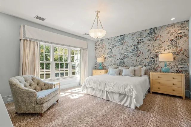 a spacious bedroom with a bed and a couch