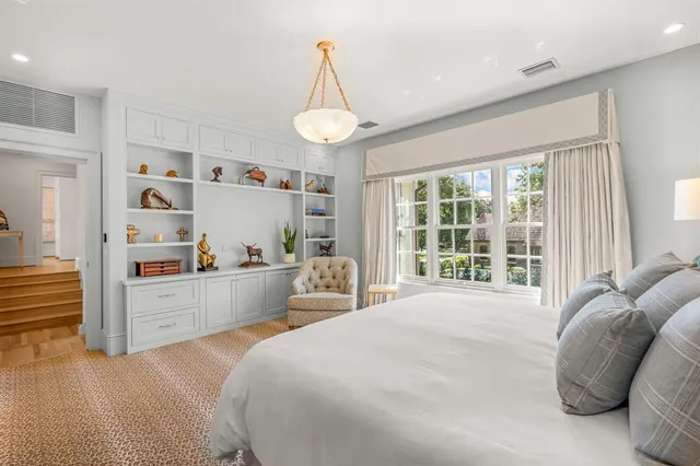 a spacious bedroom with a bed and a large window