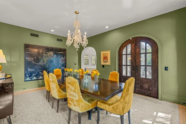 a view of a dining room with furniture and chandelier