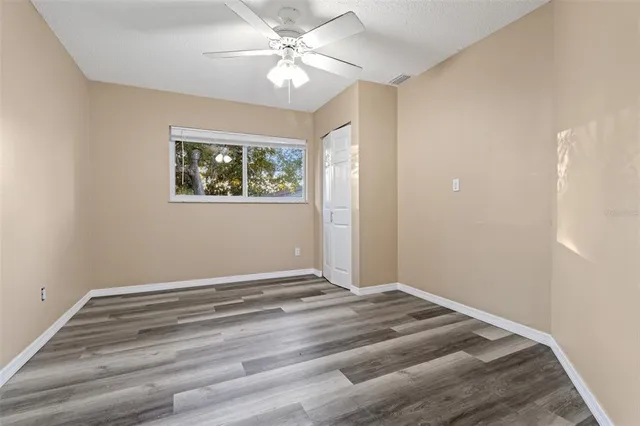 a view of room with window and ceiling fan