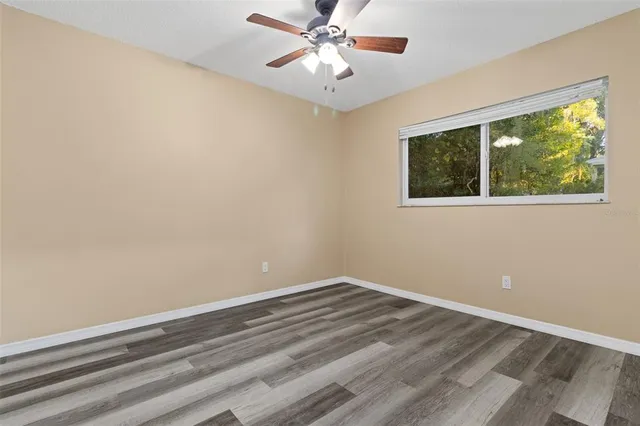 a room with a window and ceiling fan