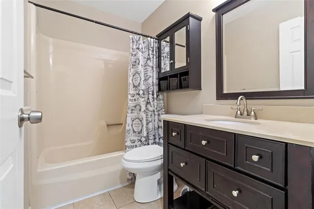 a bathroom with a double vanity sink toilet and shower