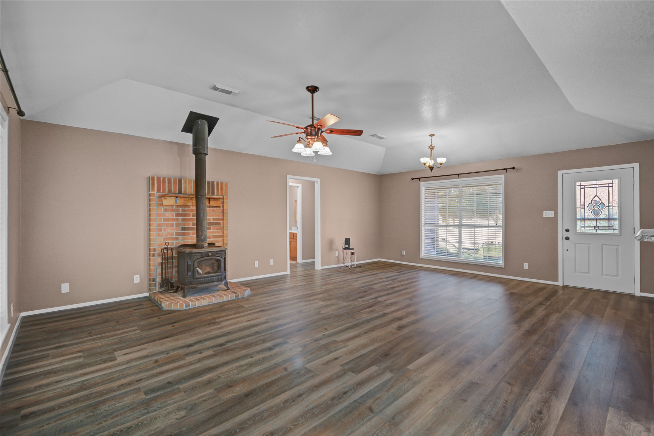 21503 Pecan Bend Road Damon, TX 77430 - Photo 11 of 39 an empty room with wooden floor and windows
