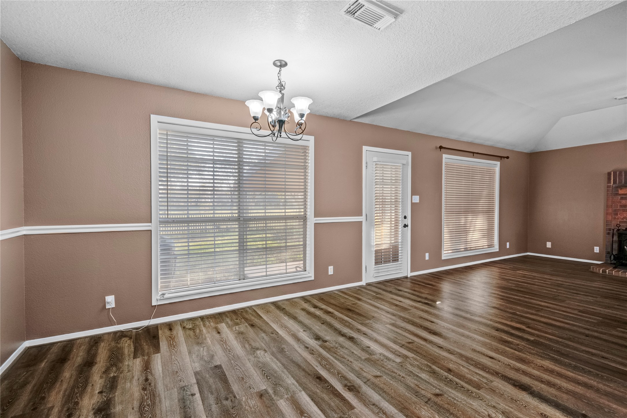21503 Pecan Bend Road Damon, TX 77430 - Photo 13 of 39 a view of an empty room with wooden floor and a window