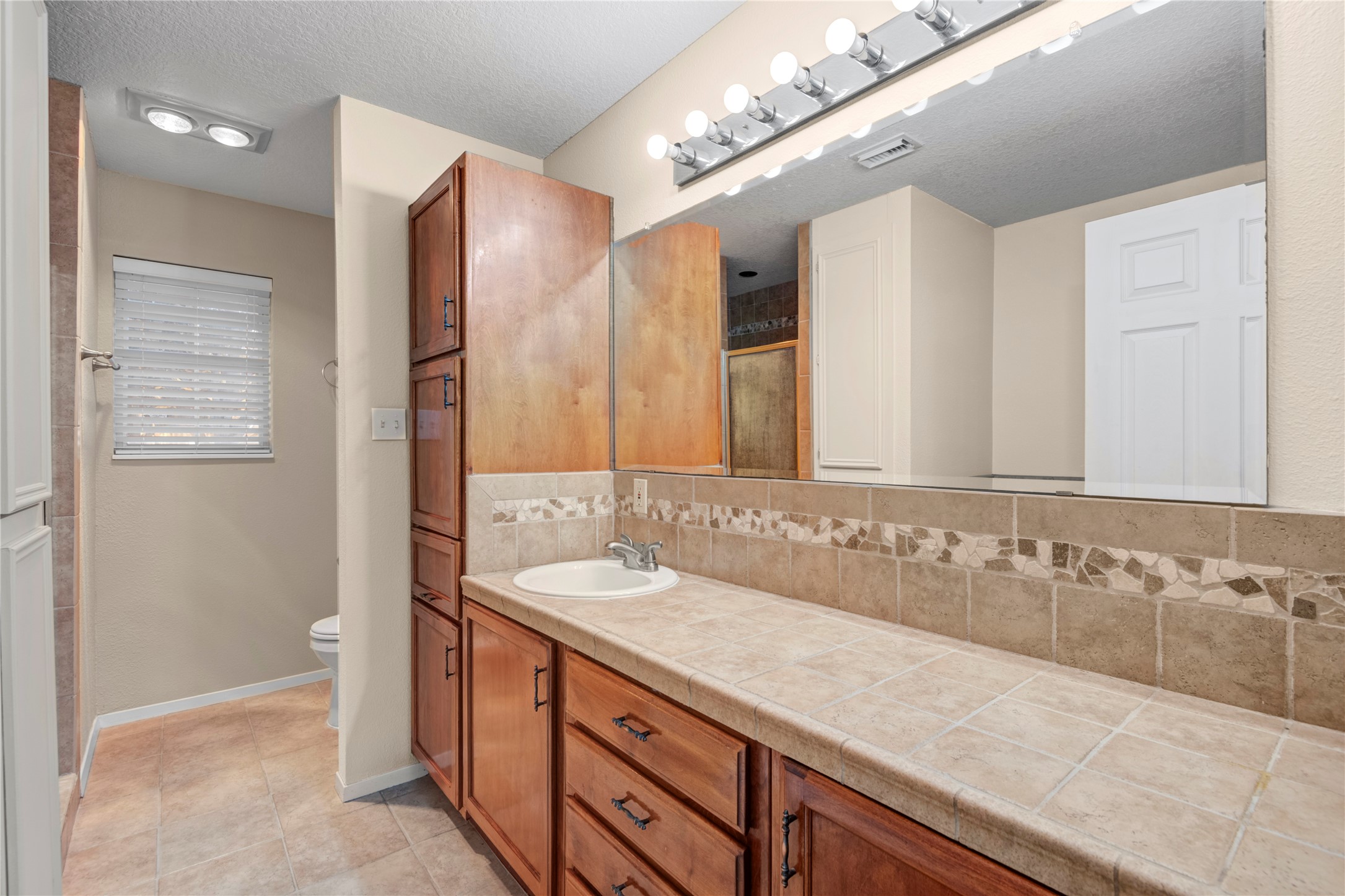 21503 Pecan Bend Road Damon, TX 77430 - Photo 25 of 39 a bathroom with a double vanity sink and a mirror