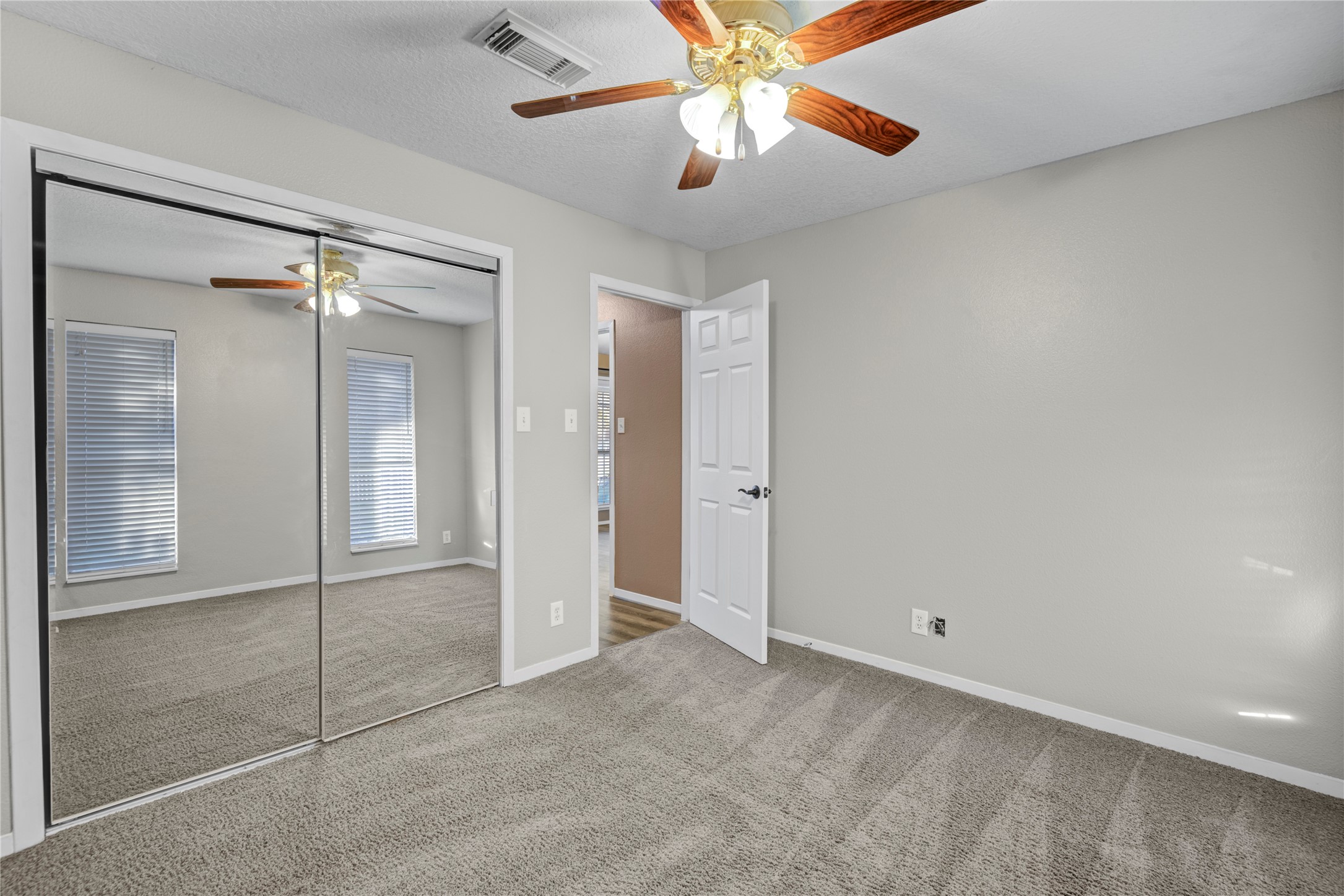 21503 Pecan Bend Road Damon, TX 77430 - Photo 34 of 39 an empty room with windows and fan