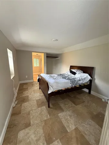 a bedroom with a bed and window