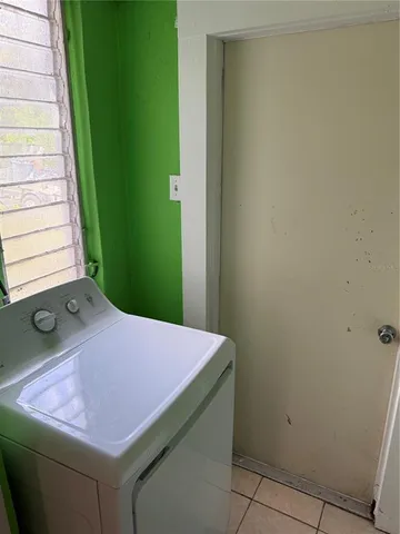 a room with washing machine and window