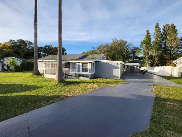 a view of a house with a yard and sitting area