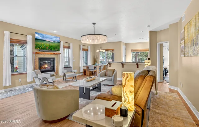 a living room with furniture and a chandelier