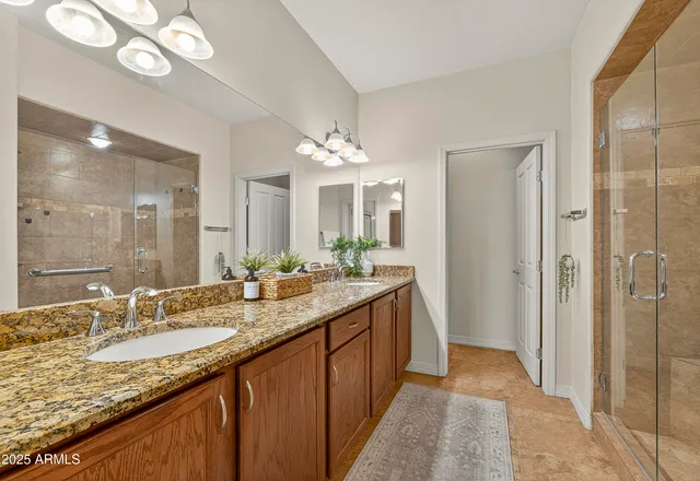 a spacious bathroom with a granite countertop sink and a mirror