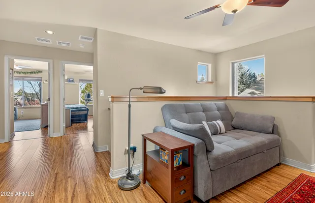 a bedroom with furniture and a large window