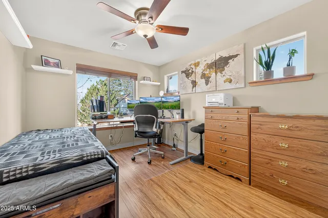 a view of walk in closet with hardwood floor