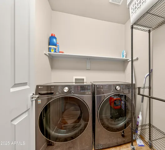 a spacious bedroom with a bed and ceiling fan