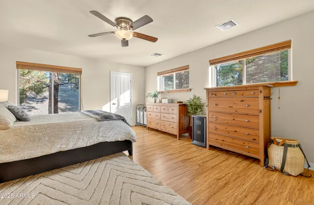 a bathroom with a granite countertop sink a large mirror and a bathtub with shower
