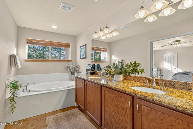 a white bath tub sitting next to a white sink