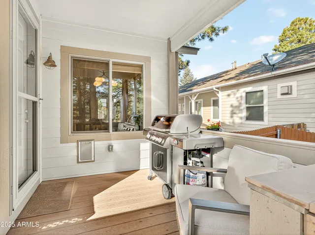 a front view of a house with a tree