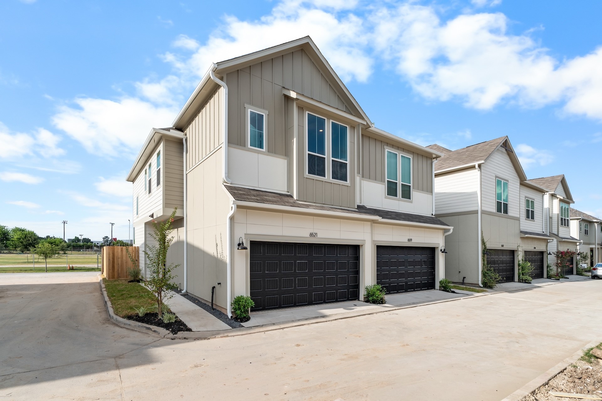 6521 Rena Street Houston, TX 77092 - Photo 2 of 24 Striking curb appeal — multi-unit architectural facade, manicured front landscaping bed, and broad concrete driveway providing ample guest parking.