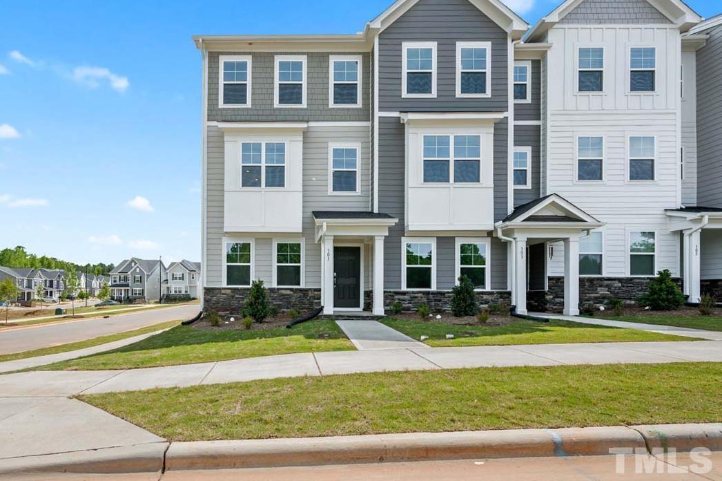 a front view of building with yard and green space