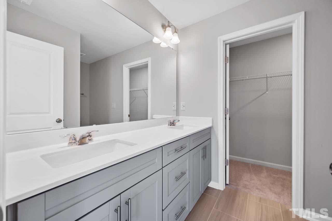 301 Devon Cliffs Drive Wake Forest, NC 27587 - Photo 11 of 26 a bathroom with a sink vanity and a mirror