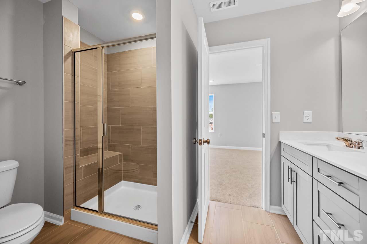 301 Devon Cliffs Drive Wake Forest, NC 27587 - Photo 12 of 26 a bathroom with a shower and a toilet