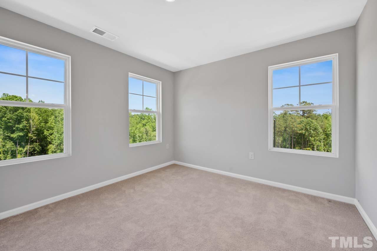 301 Devon Cliffs Drive Wake Forest, NC 27587 - Photo 20 of 26 an empty room with windows