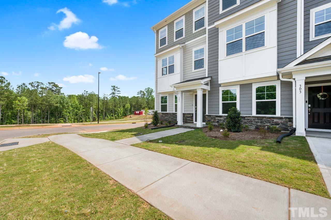 301 Devon Cliffs Drive Wake Forest, NC 27587 - Photo 2 of 26 a view of yellow house with swimming pool