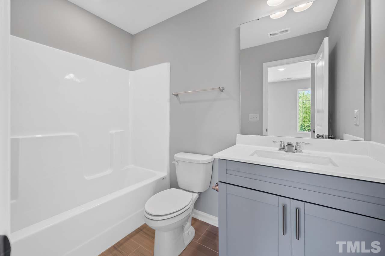 301 Devon Cliffs Drive Wake Forest, NC 27587 - Photo 21 of 26 a bathroom with a sink a toilet and shower