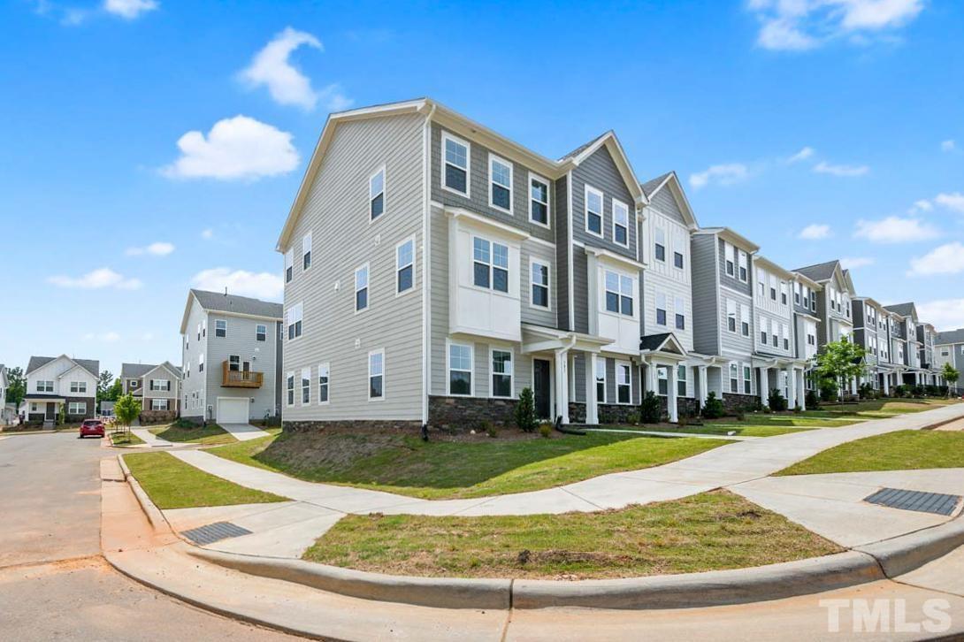 301 Devon Cliffs Drive Wake Forest, NC 27587 - Photo 3 of 26 a view of a building with a yard