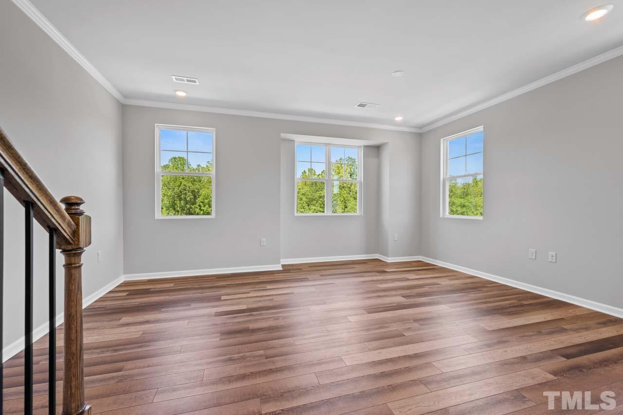 301 Devon Cliffs Drive Wake Forest, NC 27587 - Photo 7 of 26 a view of an empty room with wooden floor and a window