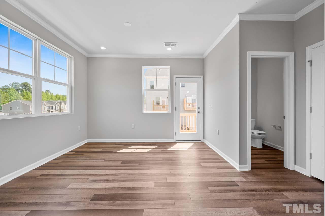 301 Devon Cliffs Drive Wake Forest, NC 27587 - Photo 9 of 26 a view of an empty room with wooden floor and a window