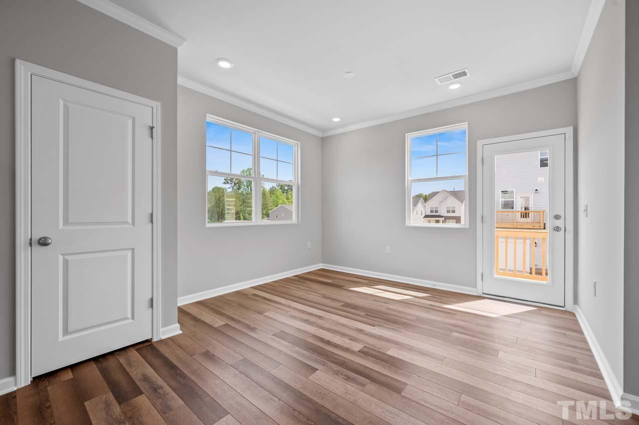 301 Devon Cliffs Drive Wake Forest, NC 27587 - Photo 10 of 26 a view of empty room with wooden floor and fan