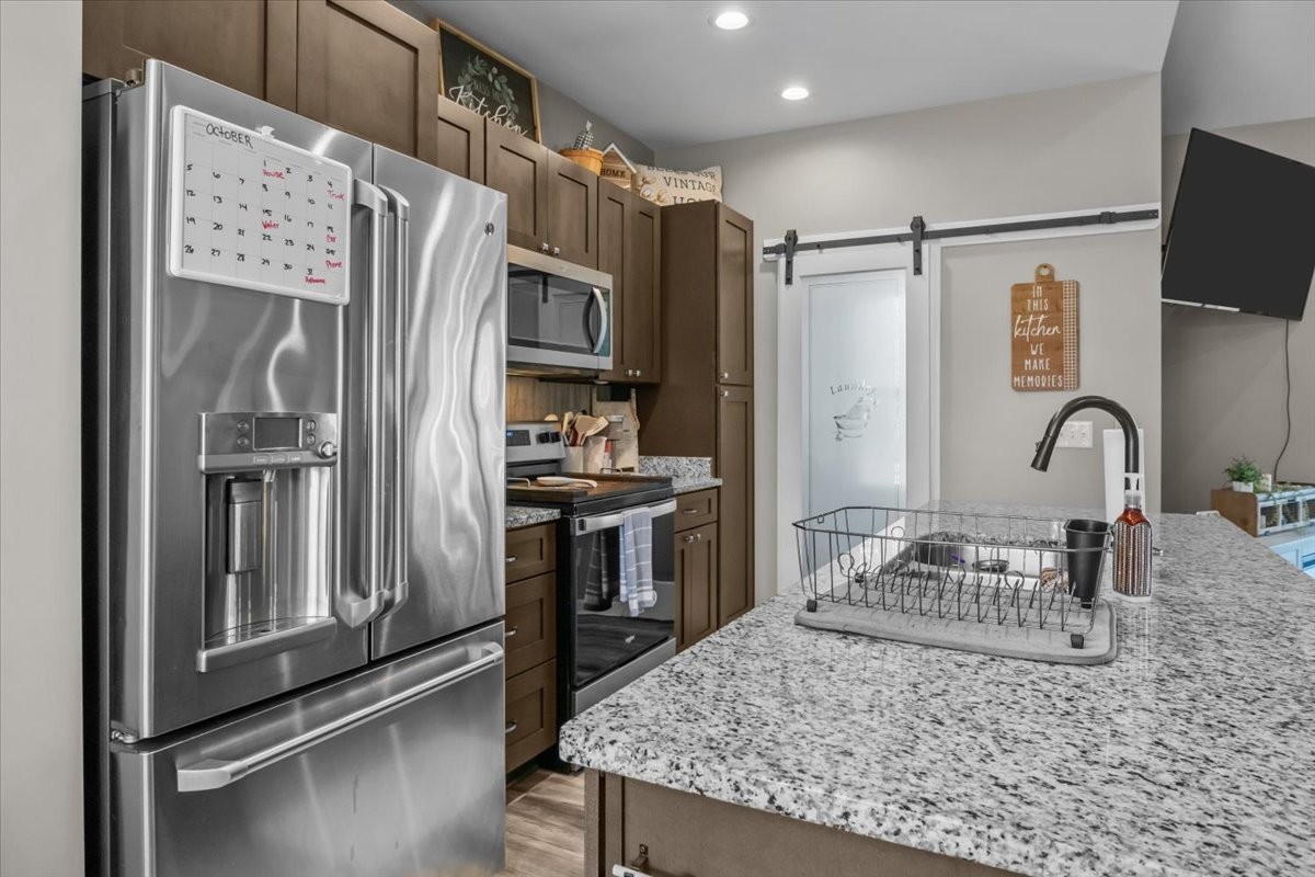 120 Pinethicket Road McEwen, TN 37101 - Photo 11 of 36 a kitchen with stainless steel appliances granite countertop a refrigerator a stove and a sink