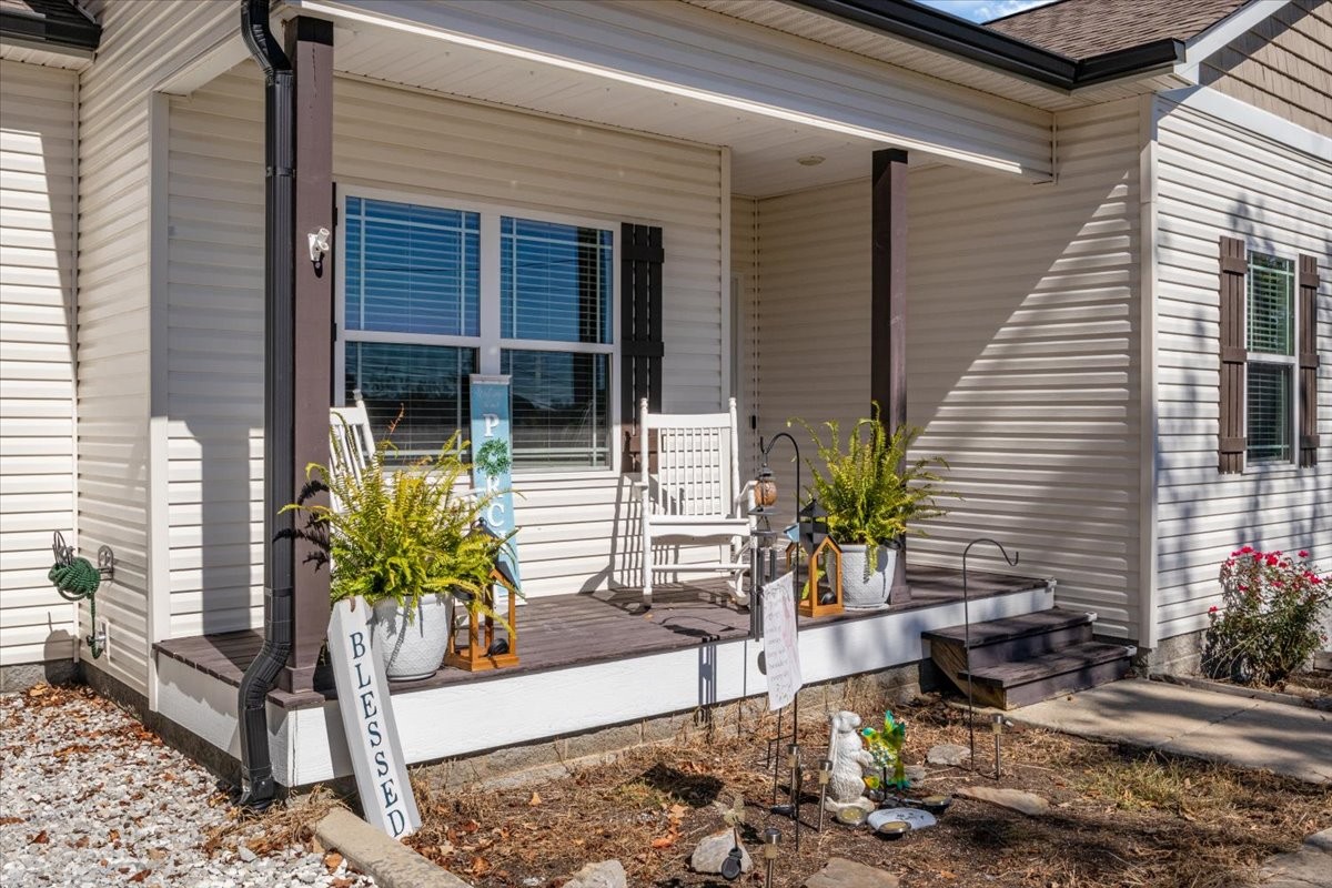 120 Pinethicket Road McEwen, TN 37101 - Photo 2 of 36 a potted plant sitting in front of a house