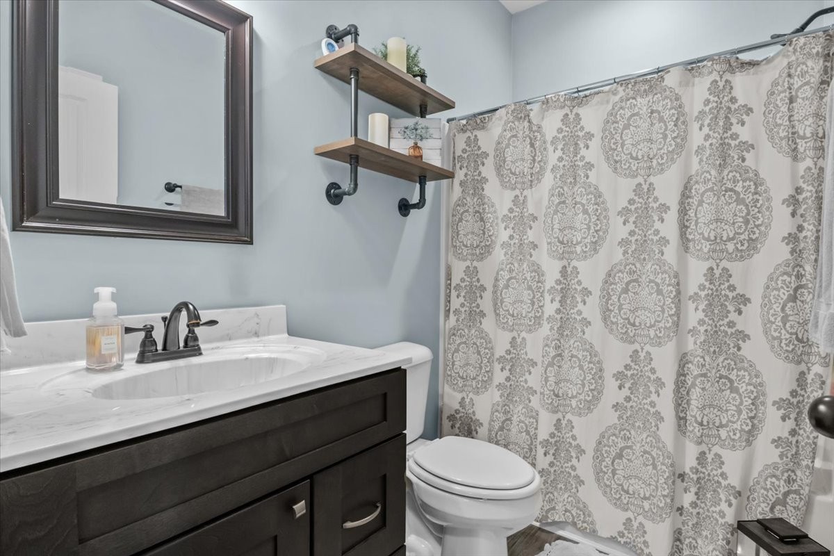 120 Pinethicket Road McEwen, TN 37101 - Photo 23 of 36 a bathroom with a granite countertop sink a toilet and a mirror
