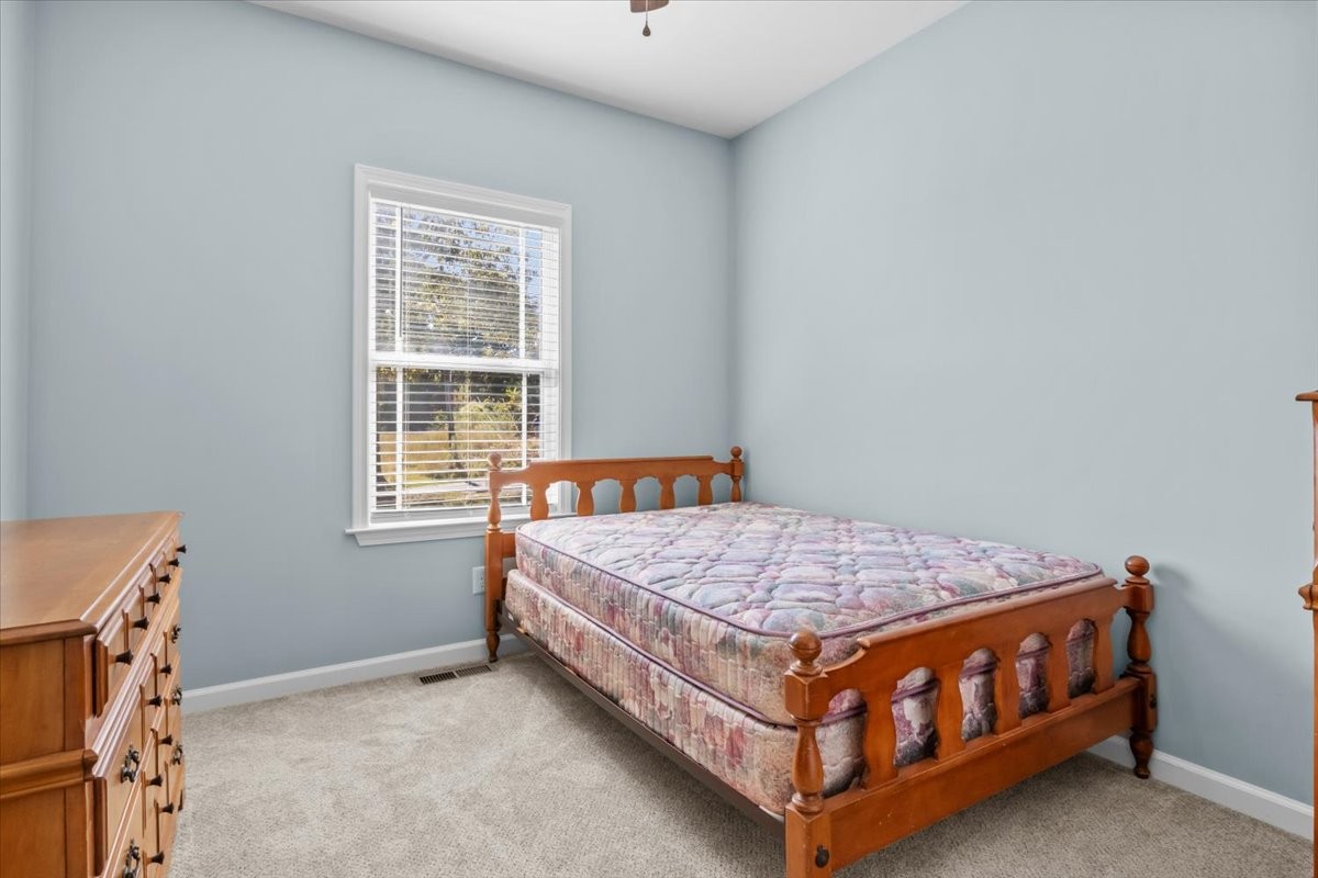 120 Pinethicket Road McEwen, TN 37101 - Photo 24 of 36 a bed sitting in a bedroom next to a window
