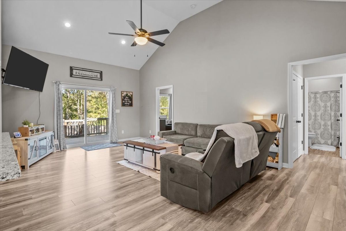 120 Pinethicket Road McEwen, TN 37101 - Photo 6 of 36 a spacious bedroom with a bed a couch and a flat screen tv