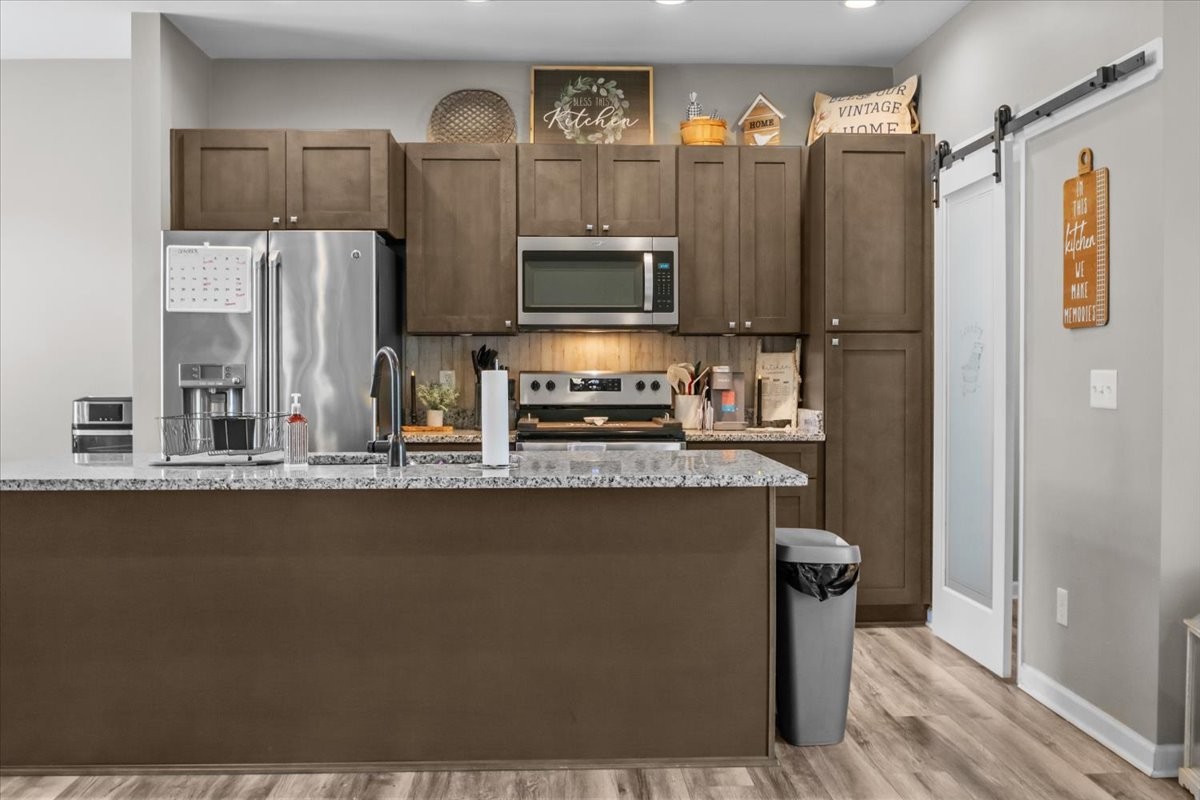 120 Pinethicket Road McEwen, TN 37101 - Photo 8 of 36 a kitchen with stainless steel appliances granite countertop a refrigerator a stove and a sink