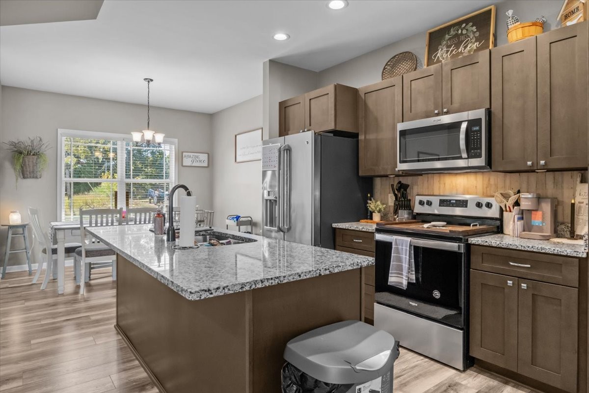 120 Pinethicket Road McEwen, TN 37101 - Photo 9 of 36 a kitchen with stainless steel appliances granite countertop a sink stove and refrigerator
