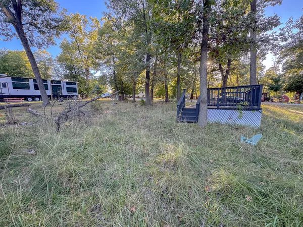 a view of a sitting area with trees in a yard