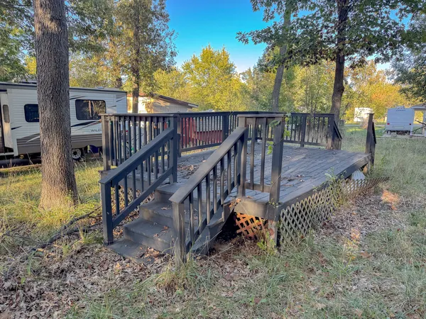 a view of an house with backyard and trees