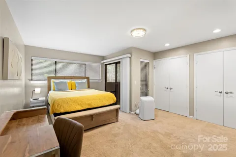 a bedroom with a bed and lamp