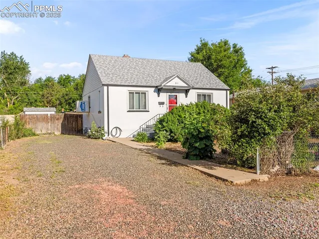 a front view of a house with a yard and a garage