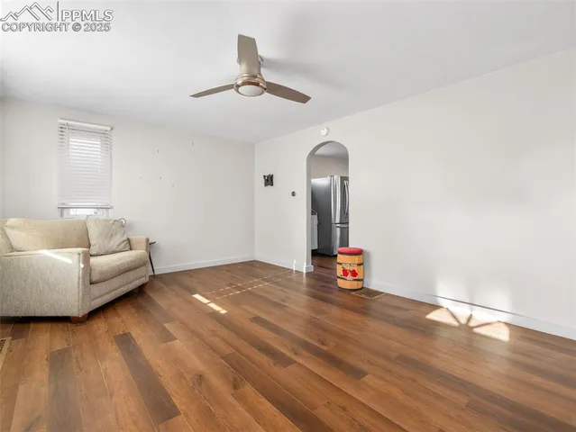 a living room with furniture and a wooden floor