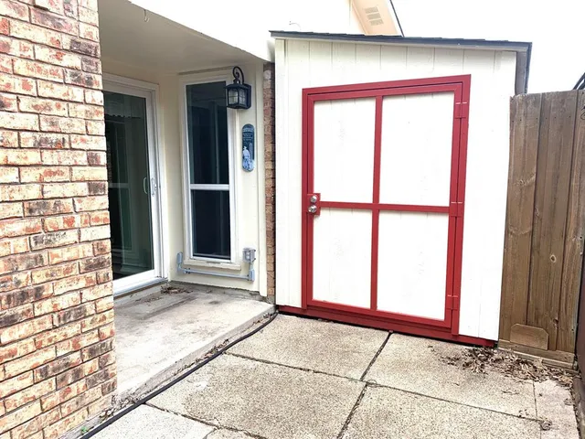 a view of a house with a door and wooden floor