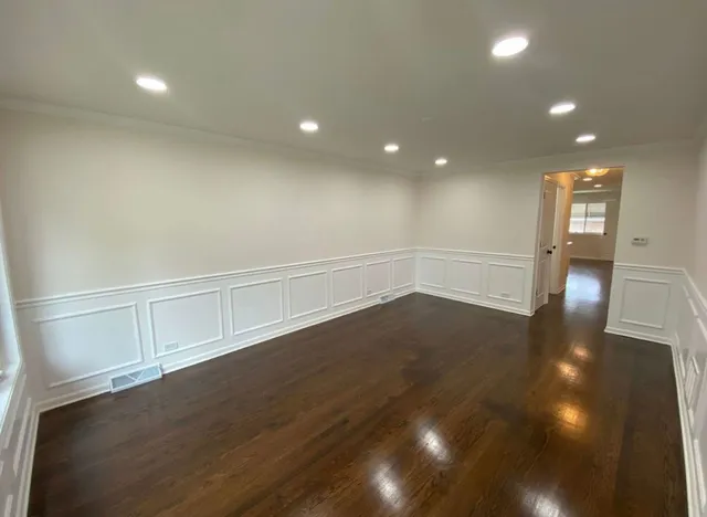 a kitchen with cabinets stainless steel appliances and a window