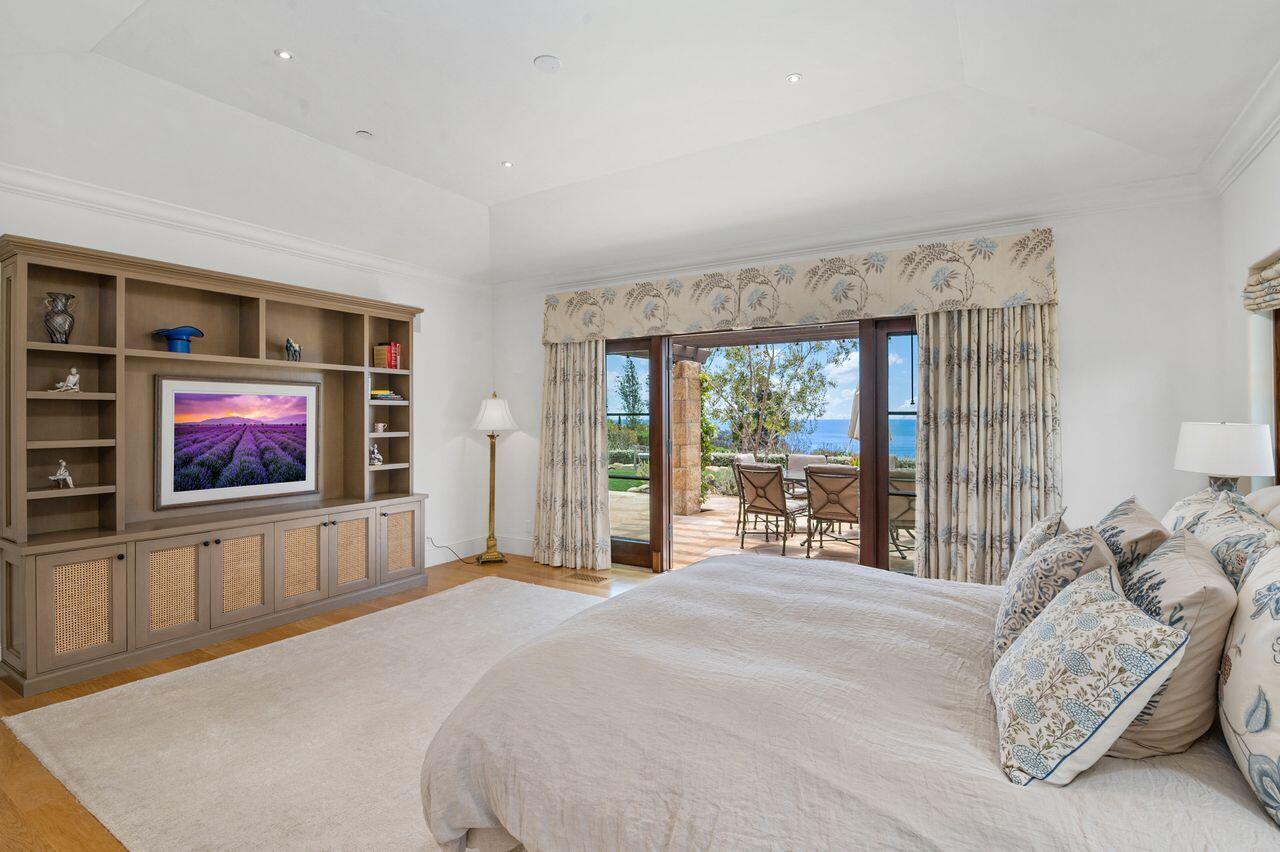 130 Montecito Ranch Lane Summerland, CA 93067 - Photo 15 of 33 a spacious bedroom with a bed and a flat screen tv