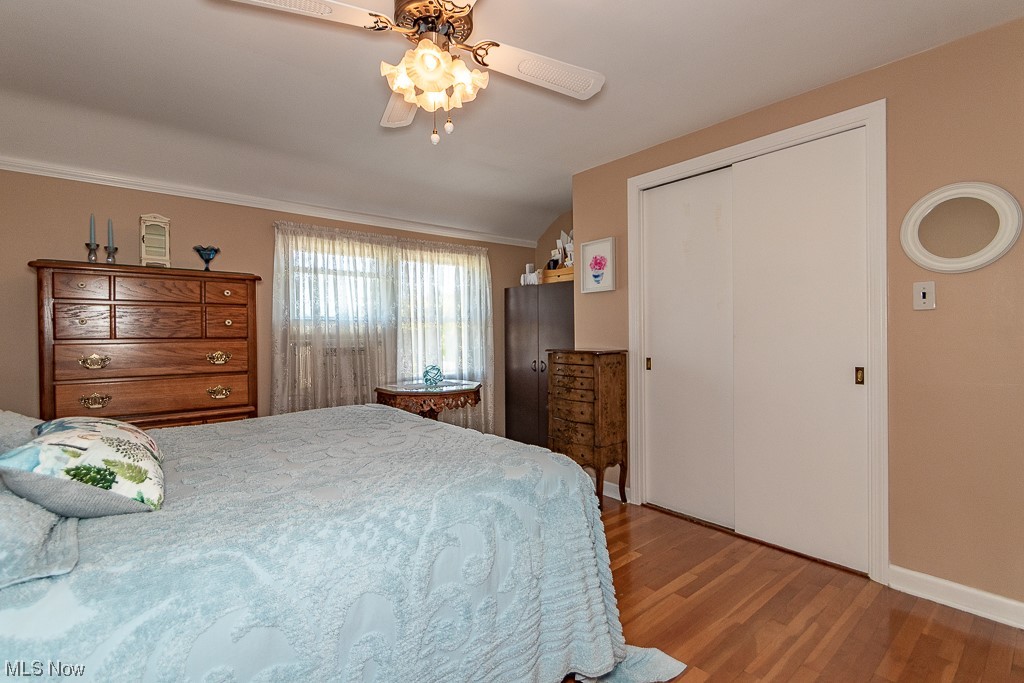 5444 Mayfield Road Cleveland, OH 44124 - Photo 16 of 34 Hardwood floored bedroom featuring vaulted ceiling, ceiling fan, and a closet